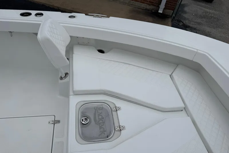 Slide: The Image of Interior of 2026 BlackJack 256 Coastal boat with white seating and storage. - 8