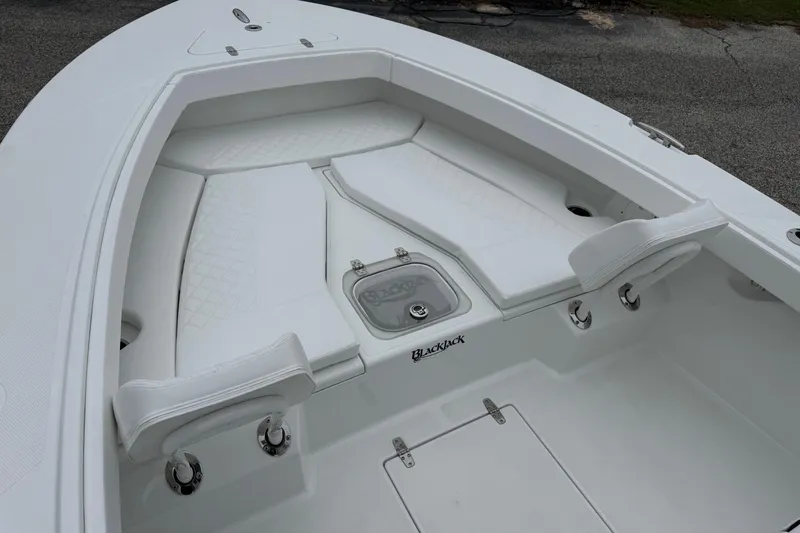 Slide: The Image of 2026 BlackJack 256 Coastal boat interior with white seating and storage compartments. - 9