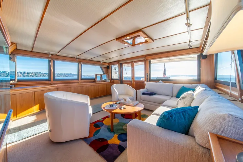 Slide: The Image of Luxurious interior of 1991 Tollycraft 57 Pilothouse Motor Yacht with panoramic windows and plush seating. - 10
