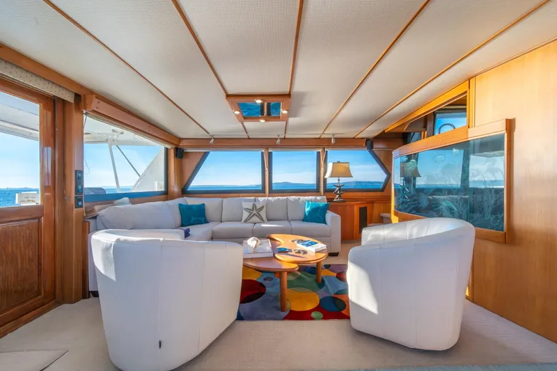 Slide: The Image of Luxurious interior of 1991 Tollycraft 57 Pilothouse Motor Yacht with panoramic windows and elegant seating. - 11