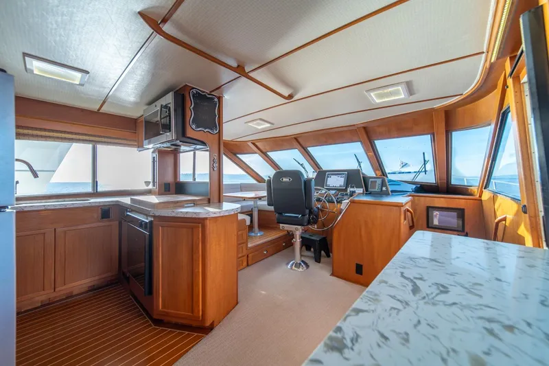 Slide: The Image of Interior of 1991 Tollycraft 57 Pilothouse Motor Yacht with modern helm and kitchen area. - 15