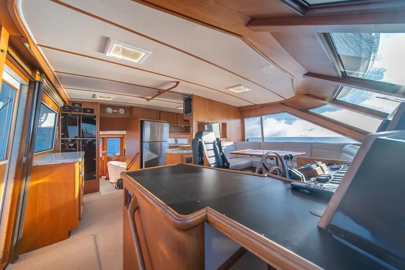 Slide: The Image of Interior of 1991 Tollycraft 57 Pilothouse Motor Yacht with modern helm and seating area. - 16