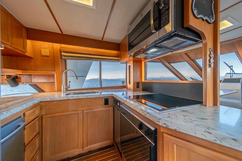 Slide: The Image of Luxurious kitchen interior of 1991 Tollycraft 57 Pilothouse Motor Yacht with ocean view. - 21