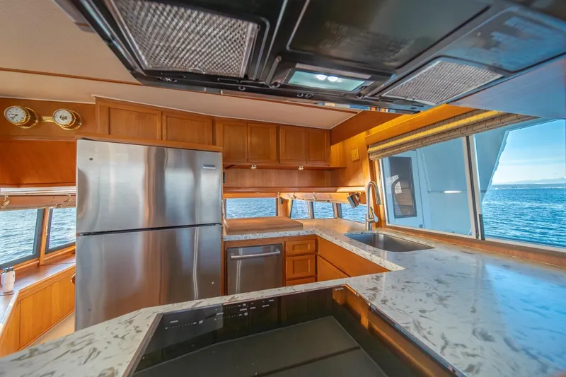 Slide: The Image of Luxurious kitchen interior of 1991 Tollycraft 57 Pilothouse Motor Yacht with ocean view. - 23