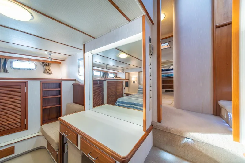 Slide: The Image of Luxurious interior of 1991 Tollycraft 57 Pilothouse Motor Yacht with elegant wood finishes. - 27