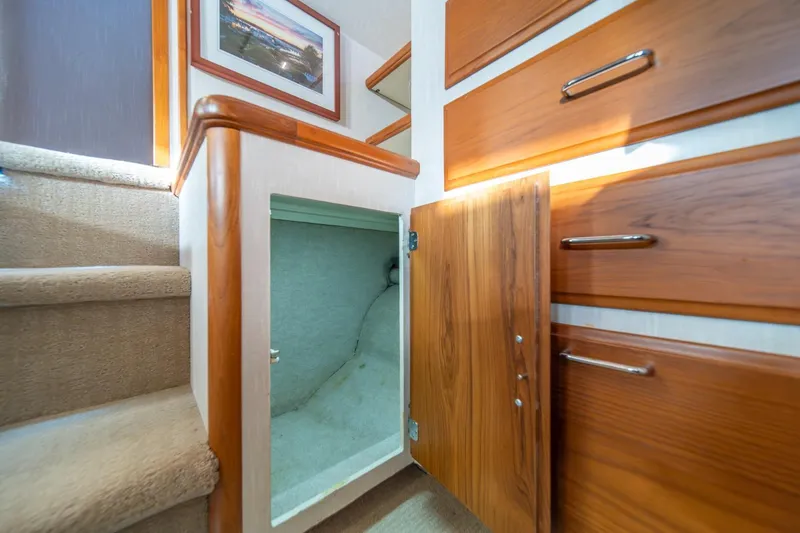 Slide: The Image of Interior of 1991 Tollycraft 57 Pilothouse Motor Yacht with open storage compartment. - 28