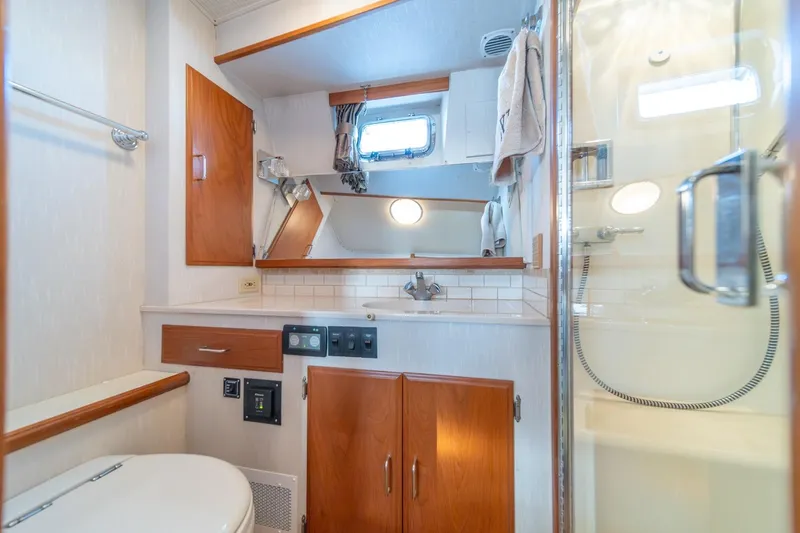 Slide: The Image of Bathroom interior of 1991 Tollycraft 57 Pilothouse Motor Yacht, featuring wood cabinetry and shower. - 31