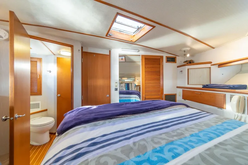 Slide: The Image of 1991 Tollycraft 57 Pilothouse Motor Yacht bedroom with skylight and ensuite bathroom. - 33