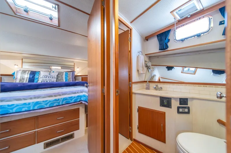 Slide: The Image of Luxurious 1991 Tollycraft 57 Pilothouse Motor Yacht cabin with cozy bed and ensuite bathroom. - 34