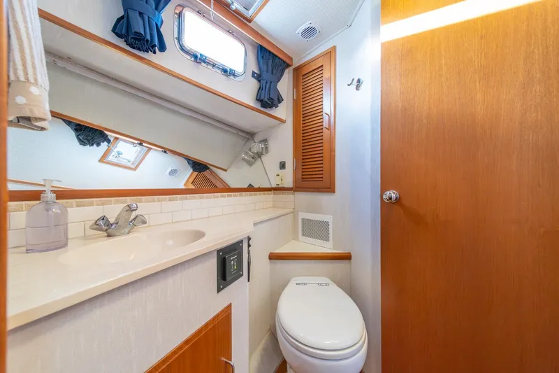 Slide: The Image of Bathroom interior of 1991 Tollycraft 57 Pilothouse Motor Yacht, featuring sink and toilet. - 35