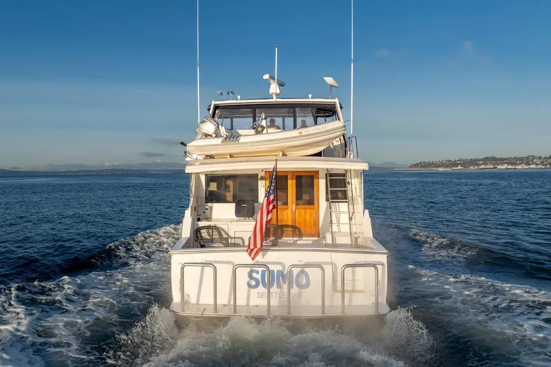 Slide: The Image of 1991 Tollycraft 57 Pilothouse Motor Yacht cruising on open water. - 4