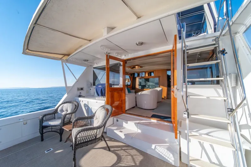 Slide: The Image of Luxurious 1991 Tollycraft 57 Pilothouse Motor Yacht with elegant outdoor seating and ocean view. - 47