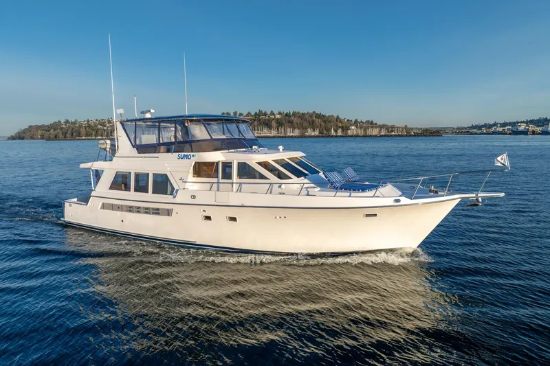Slide: The Image of 1991 Tollycraft 57 Pilothouse Motor Yacht cruising on calm waters under clear skies. - 5