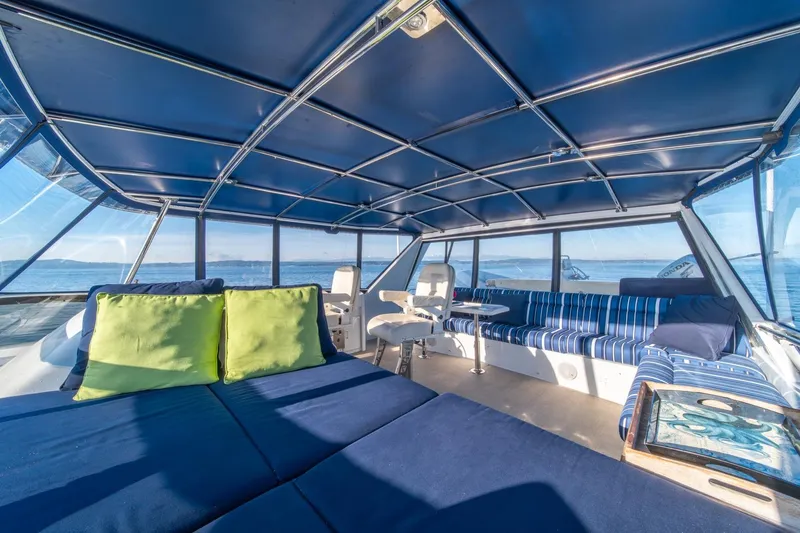 Slide: The Image of Luxurious interior of 1991 Tollycraft 57 Pilothouse Motor Yacht with blue seating and panoramic views. - 55