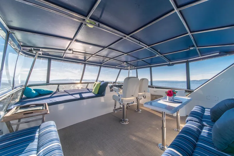Slide: The Image of Luxurious interior of 1991 Tollycraft 57 Pilothouse Motor Yacht with panoramic ocean views. - 57
