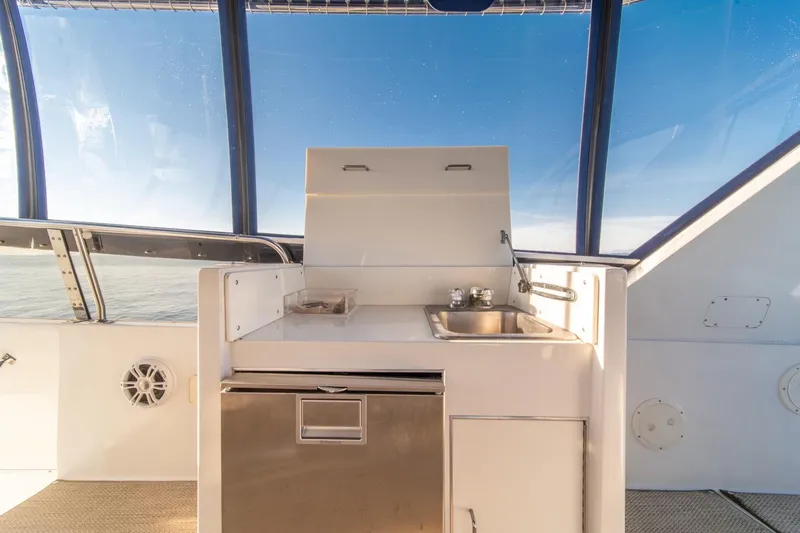 Slide: The Image of 1991 Tollycraft 57 Pilothouse Motor Yacht interior with kitchenette and ocean view. - 59