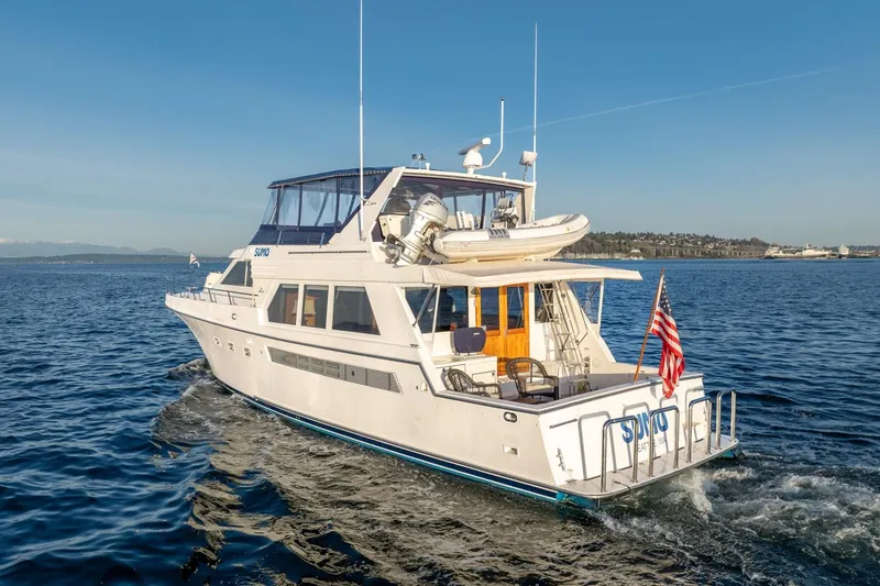 Slide: The Image of 1991 Tollycraft 57 Pilothouse Motor Yacht cruising on open water. - 6