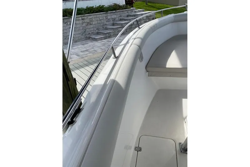 Slide: The Image of 2005 Century 2900 Center Console boat interior with cushioned seating and stainless steel railing. - 17