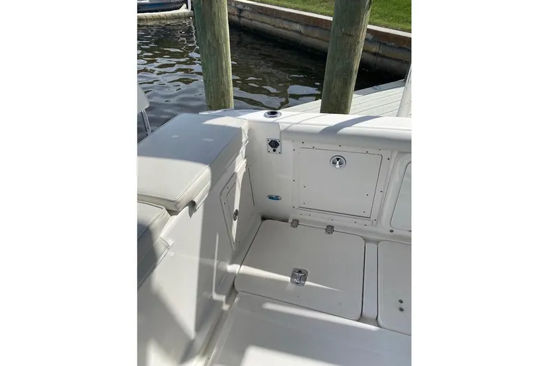 Slide: The Image of 2005 Century 2900 Center Console boat interior with storage compartments and seating. - 21