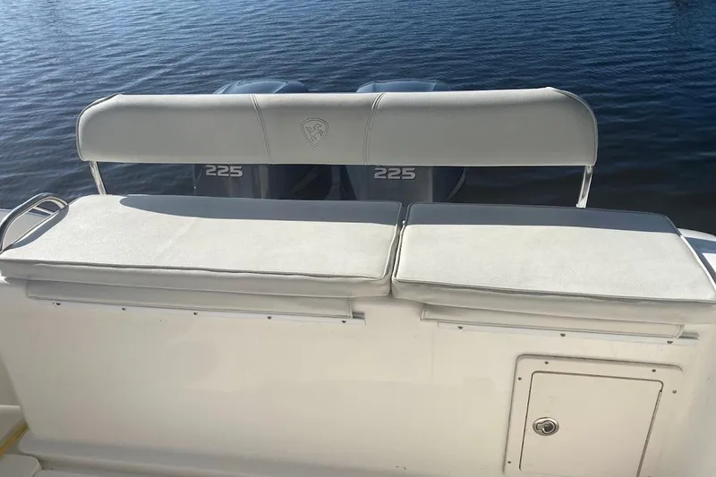 Slide: The Image of Century 2900 Center Console 2005 boat with cushioned seating and twin 225 engines. - 22