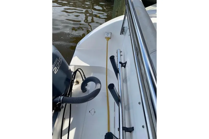 Slide: The Image of 2005 Century 2900 Center Console boat with Yamaha 225 engine, docked by water. - 23