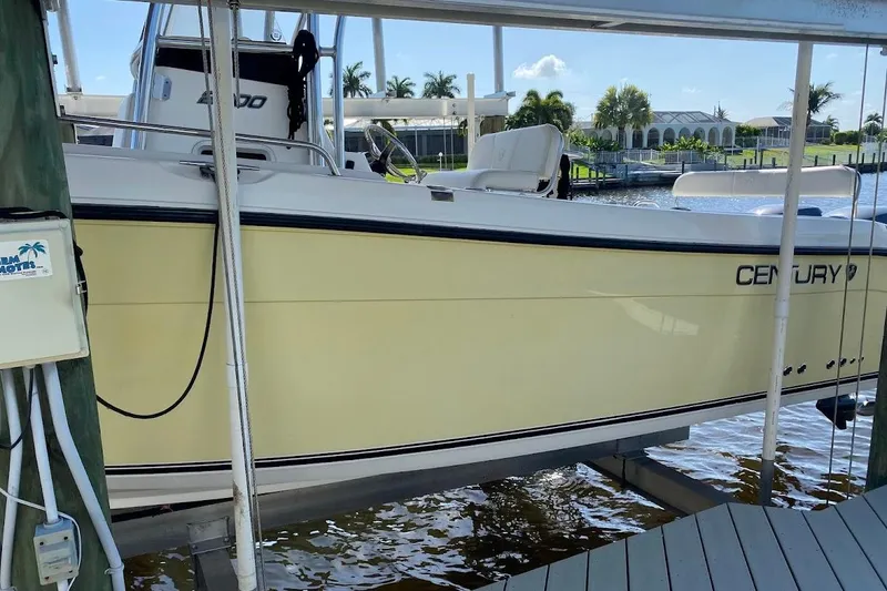 Slide: The Image of 2005 Century 2900 Center Console boat docked by waterfront homes. - 3
