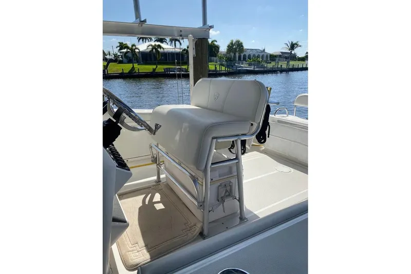 Slide: The Image of 2005 Century 2900 Center Console boat interior with steering wheel and seating, near waterfront. - 8