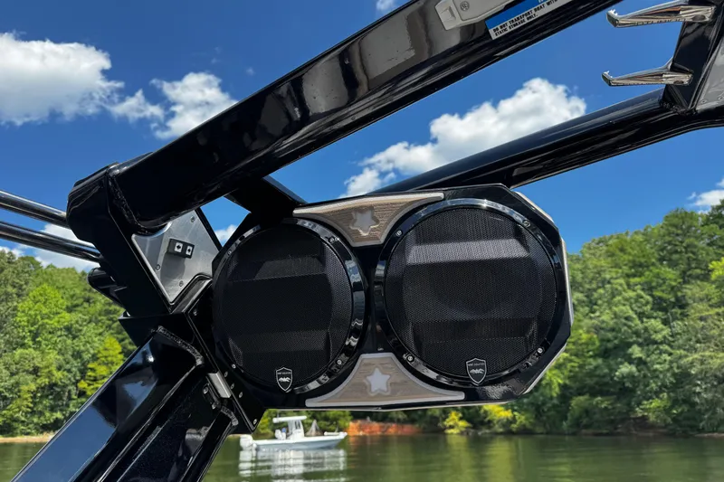 Slide: The Image of 2023 Centurion Ri265 boat speakers against a clear blue sky and lush greenery. - 12