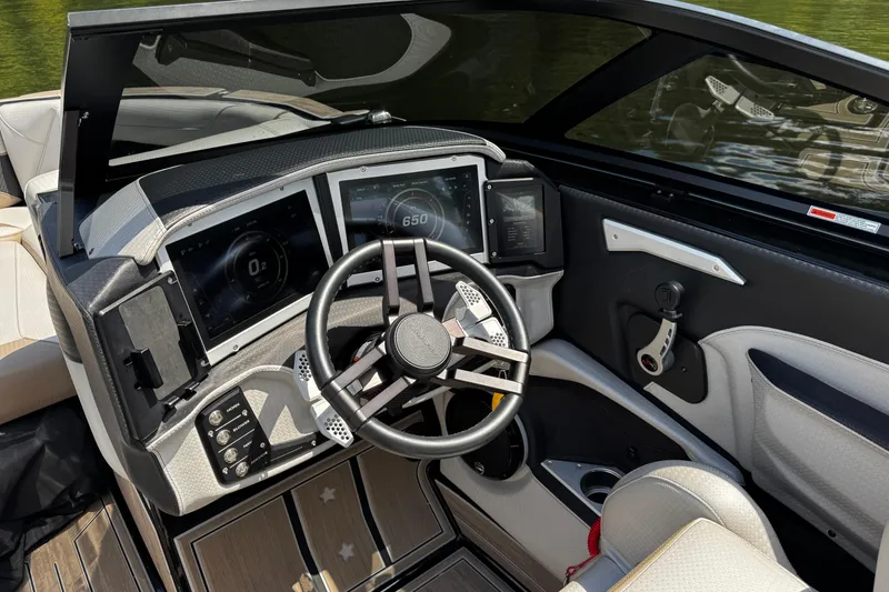 Slide: The Image of 2023 Centurion Ri265 boat dashboard with modern controls and steering wheel. - 13