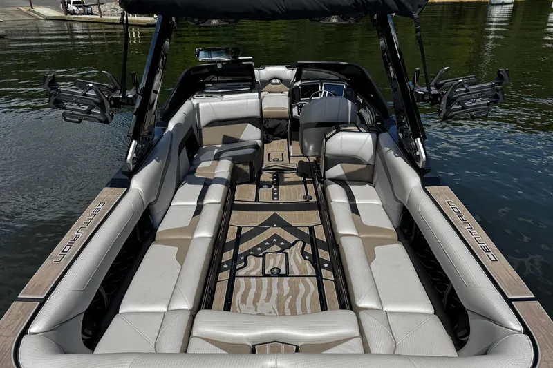 Slide: The Image of 2023 Centurion Ri265 boat interior with luxurious seating and sleek design on the water. - 16