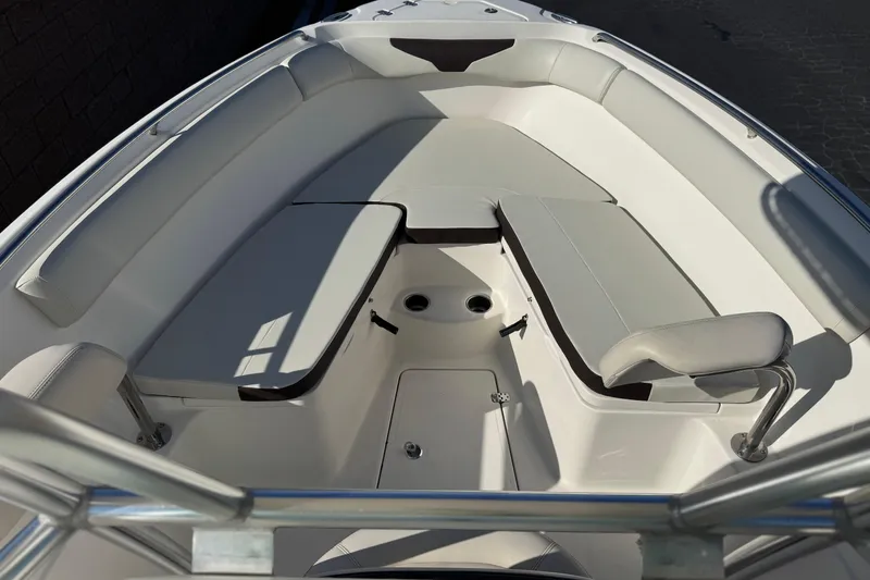 Slide: The Image of 2022 Sailfish 242 CC boat interior with cushioned seating and sleek design. - 11