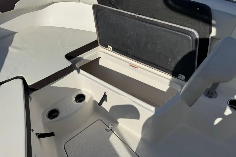 Slide: The Image of 2022 Sailfish 242 CC boat interior with open storage compartment. - 14