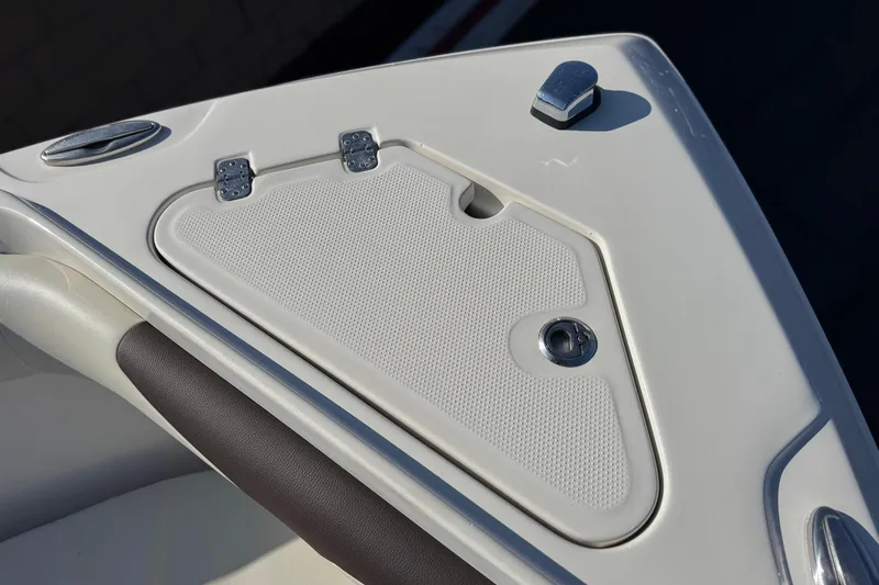 Slide: The Image of 2022 Sailfish 242 CC boat deck with storage compartment and latch. - 15