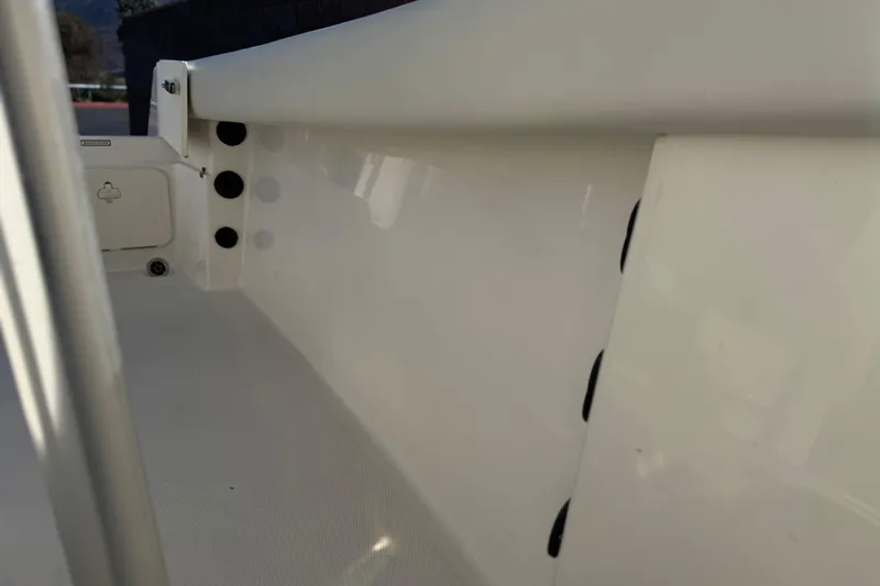 Slide: The Image of Interior view of 2022 Sailfish 242 CC boat, showcasing sleek white design and storage compartments. - 19