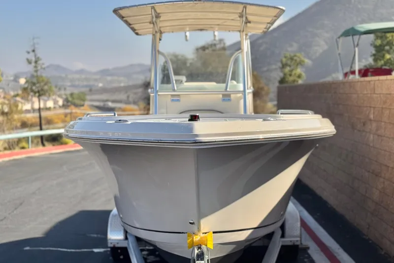 Slide: The Image of 2022 Sailfish 242 CC boat on trailer, scenic mountain backdrop. - 2
