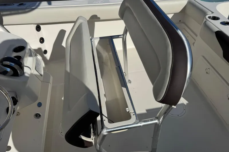 Slide: The Image of 2022 Sailfish 242 CC boat interior with open storage compartment and seating. - 21
