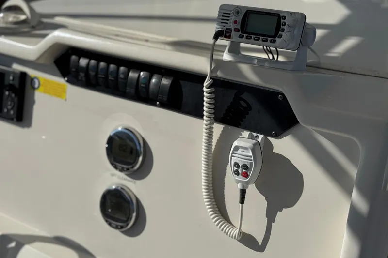 Slide: The Image of Control panel of 2022 Sailfish 242 CC boat with radio and gauges. - 27