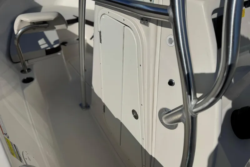 Slide: The Image of 2022 Sailfish 242 CC boat interior with stainless steel railing and seating. - 28