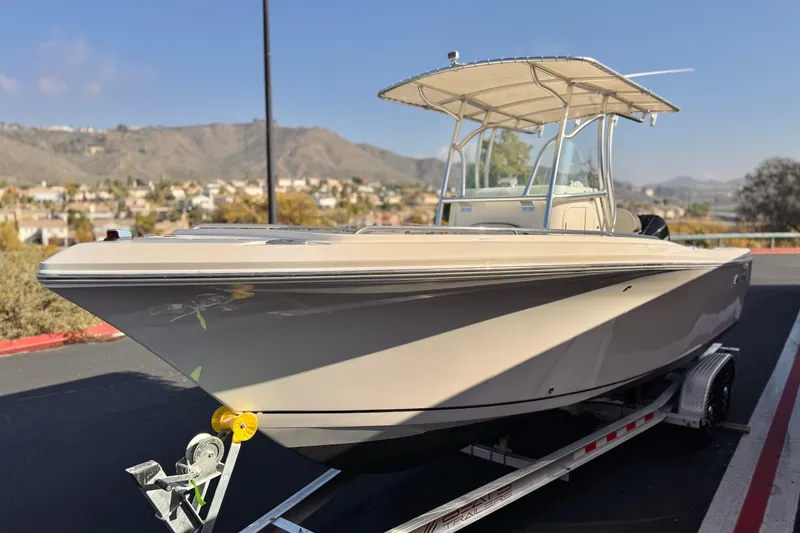 Slide: The Image of 2022 Sailfish 242 CC boat on trailer with scenic mountain backdrop. - 3
