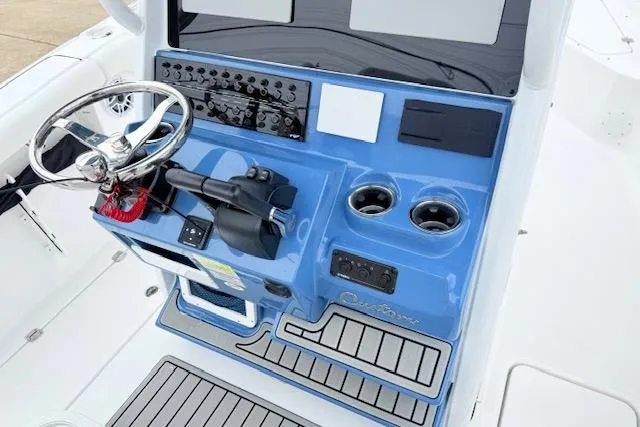 Slide: The Image of 2026 Tidewater 256 CC Adventure boat console with steering wheel and controls. - 11