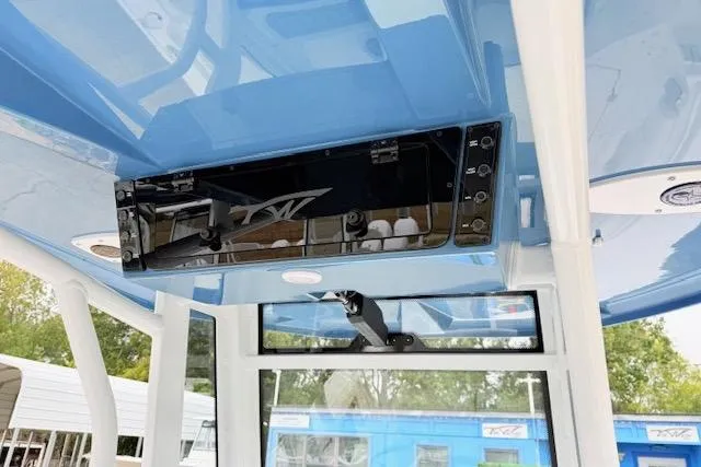 Slide: The Image of 2026 Tidewater 256 CC Adventure boat interior with blue ceiling and control panel. - 14