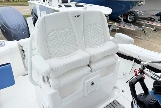 Slide: The Image of 2026 Tidewater 256 CC Adventure boat with luxurious white seating and modern design. - 15