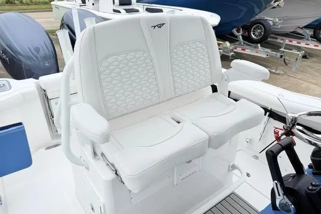 Slide: The Image of 2026 Tidewater 256 CC Adventure boat with white cushioned seating and modern design. - 16