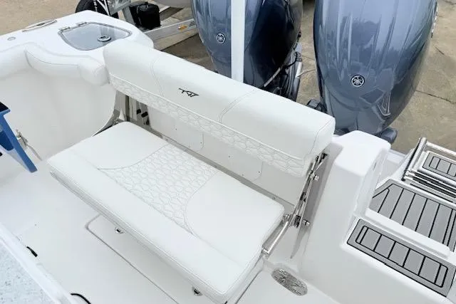 Slide: The Image of 2026 Tidewater 256 CC Adventure boat with white seating and dual engines. - 21