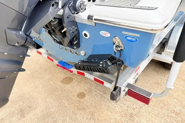 Slide: The Image of 2026 Tidewater 256 CC Adventure boat on trailer, showcasing motor and hull details. - 22