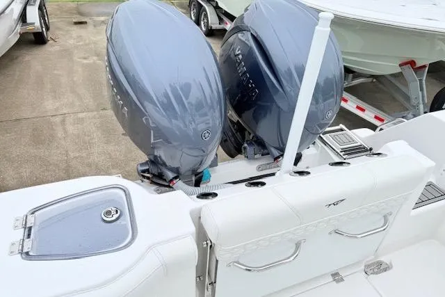 Slide: The Image of 2026 Tidewater 256 CC Adventure boat with dual outboard engines, white seating, and sleek design. - 4