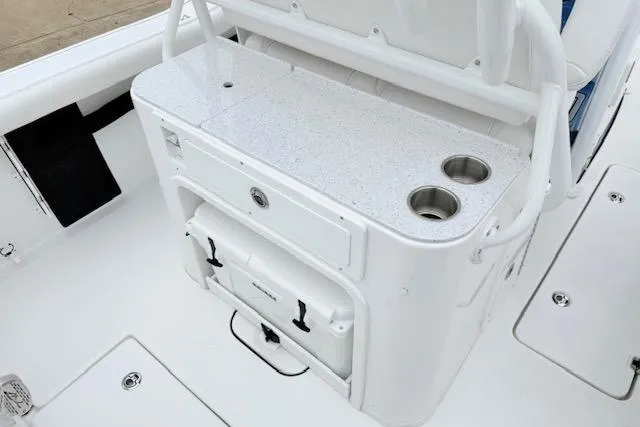 Slide: The Image of 2026 Tidewater 256 CC Adventure boat interior with storage and cup holders. - 5