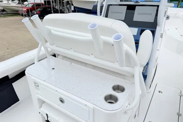 Slide: The Image of 2026 Tidewater 256 CC Adventure boat interior with rod holders and Garmin displays. - 6