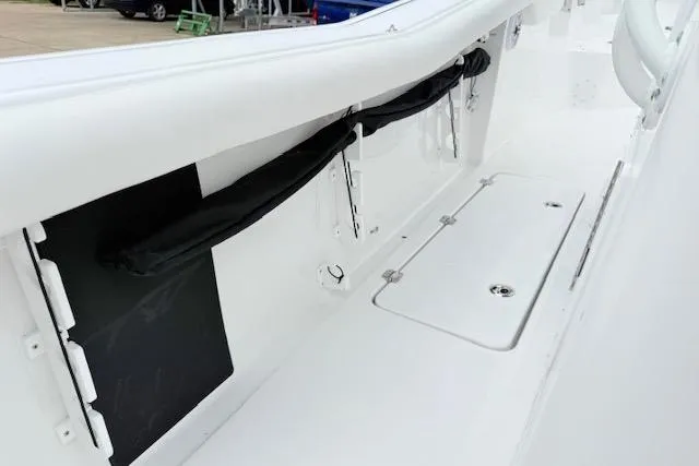 Slide: The Image of 2026 Tidewater 256 CC Adventure boat interior, featuring storage compartments and sleek white design. - 8