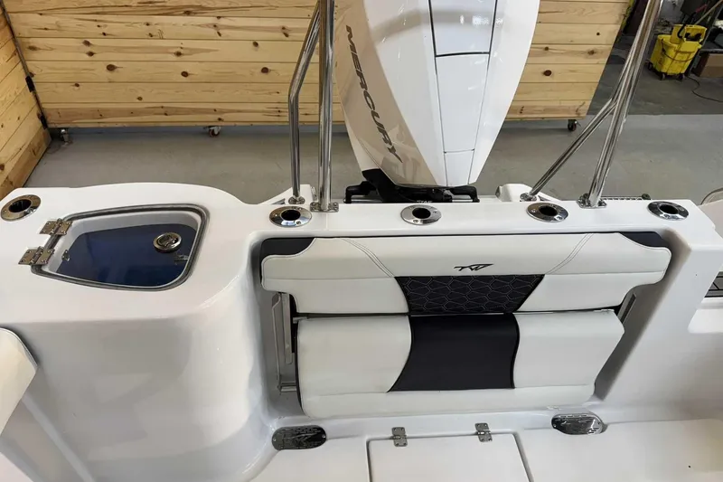 Slide: The Image of 2025 Tidewater 232 CC Adventure boat interior with seating and storage features. - 10